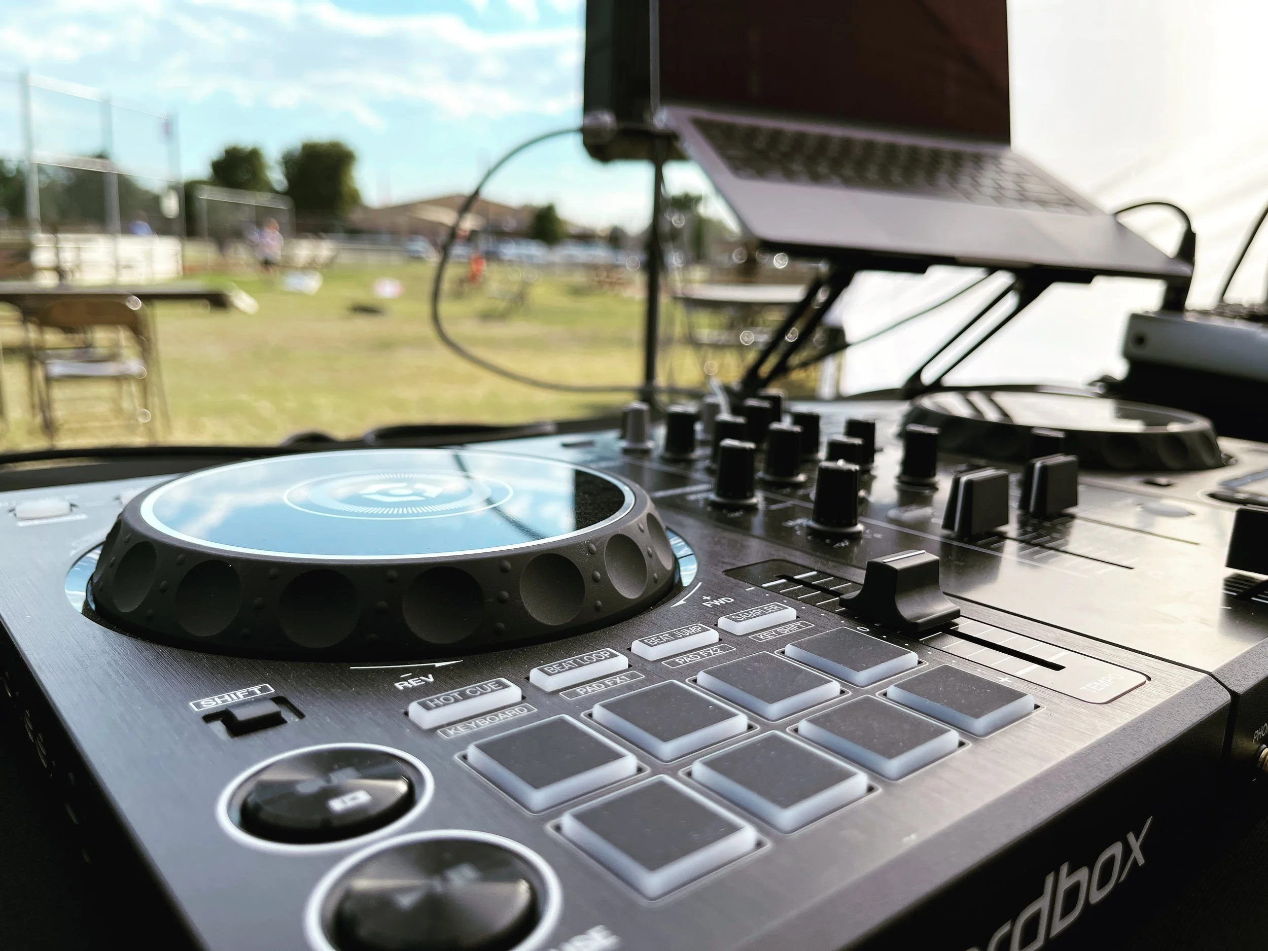 DJ controller and laptop set up outdoors at an event